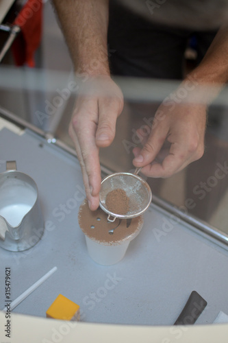 Barista prepares coffee, the process of making coffee in the cafe, the hands of the Barista close-up