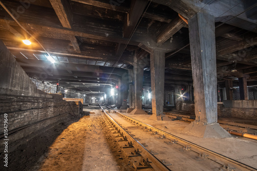 Big empty railway tunnel with many tracks near the underground railway station. Inside railway tunnel.