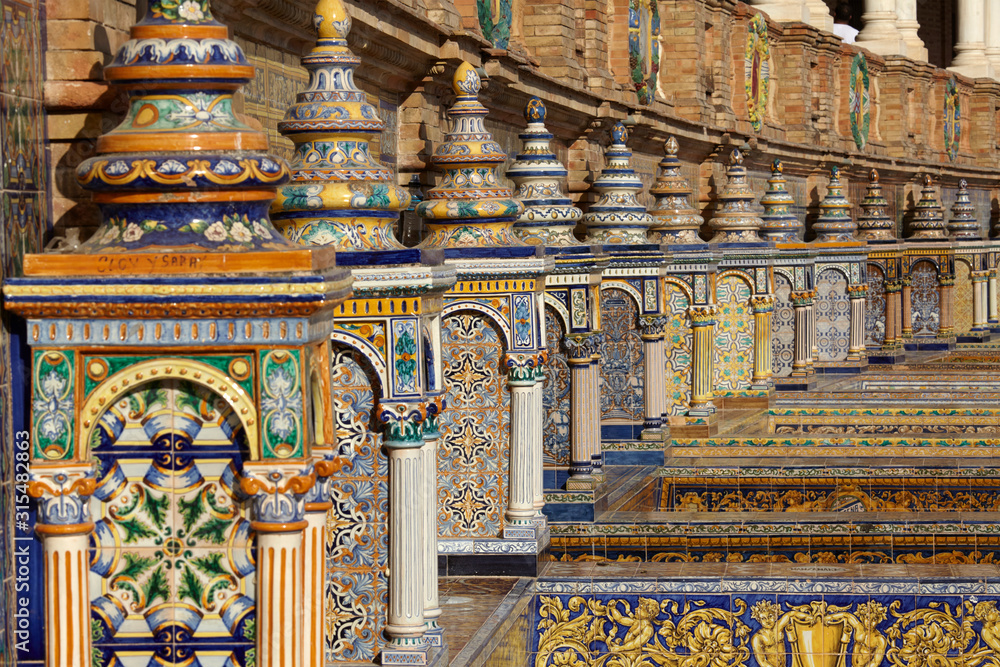 Obraz premium The tiled Provincial Alcoves in Plaza de España (Spain Square) in Seville, Spain