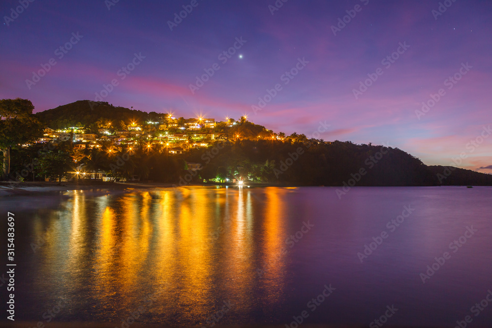 Colorful dusk sky over Anse a l’Ane beach and calm bay with peaceful Caribbean sea, Martinique island, Lesser Antilles
