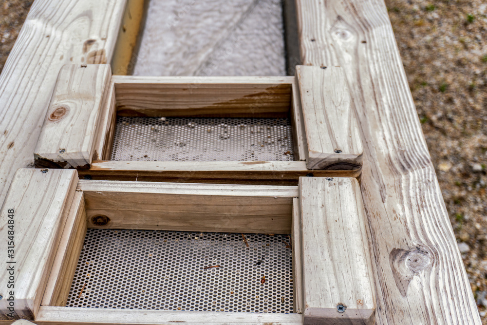 Gold mining equipment. Golden flakes has been founded. Wooden station for panning. Gold mining equipment. Golden flakes has been founded. Wooden station for panning.