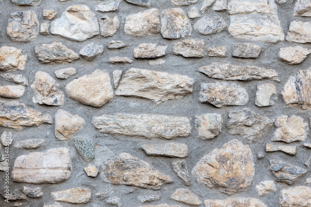 ancient wall of uneven gray stones ancient wall of uneven gray stones