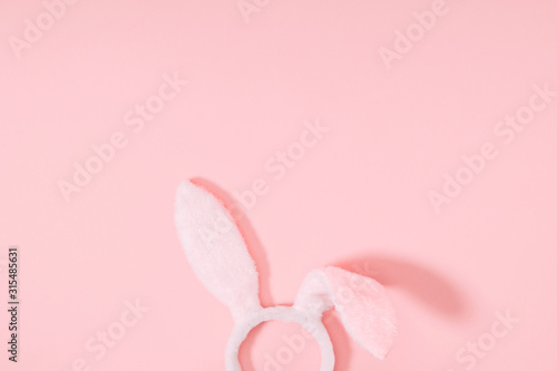 Easter pink minimal composition. Easter decoration  bunny ears on pastel pink background. Flat lay  top view  copy space