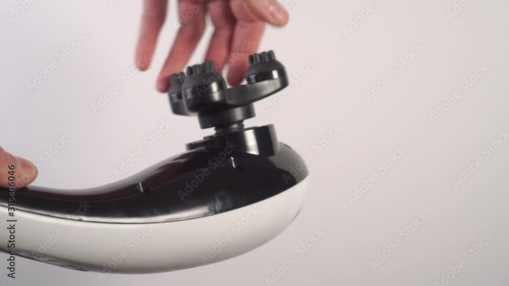 Mounting the embossed nozzle of the vibratory massager in black and white. Selection of individual massage equipment Mounting the embossed nozzle of the vibratory massager in black and white. Selection of individual massage equipment