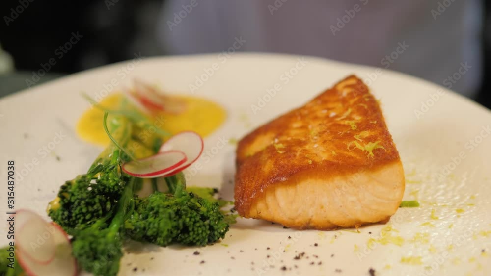 Roasted grilled salmon steak with broccoli vegetables. Fish meal with fresh vegetable in modern restaurant. Roasted grilled salmon steak with broccoli vegetables. Fish meal with fresh vegetable in modern restaurant.