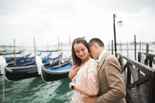 Wedding couple on the nature is hugging each other. Beautiful model girl in white dress. Man in suit.Venice, Italy
