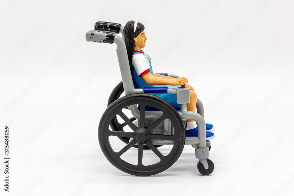 Isolated Disabled Girl in Wheelchair. Disability Toy Concept. Inclusive and Equal Opportunity Toy. - Photography