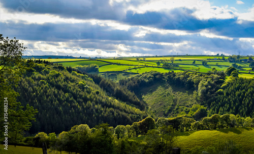 Rural Cornish lanscape, Cornwall, dramatic and dynamic sunny lanscape with green hills and cloudy blue sky