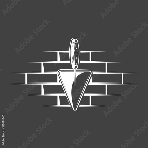 Spatulas located on a brick wall