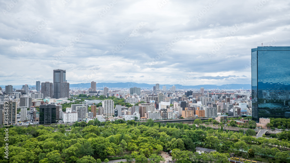 Cityscapes of the skyline in Osaka, with garden park in foreground