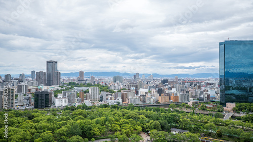 Cityscapes of the skyline in Osaka, with garden park in foreground