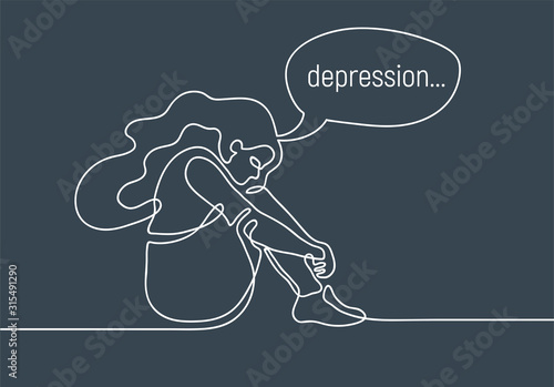 Depressed teenage girl sitting on floor