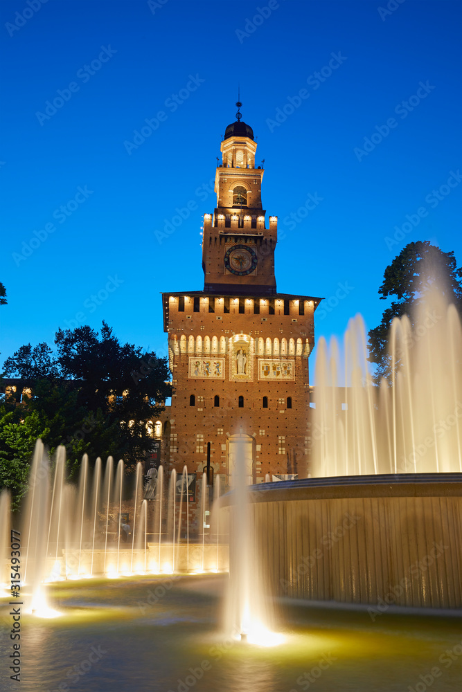 The Sforza Castle with the fountain illuminated at blue hour, Milan, Italy
