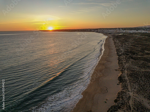 Aerial picture over Gale beach in Portugal during sunset in summer