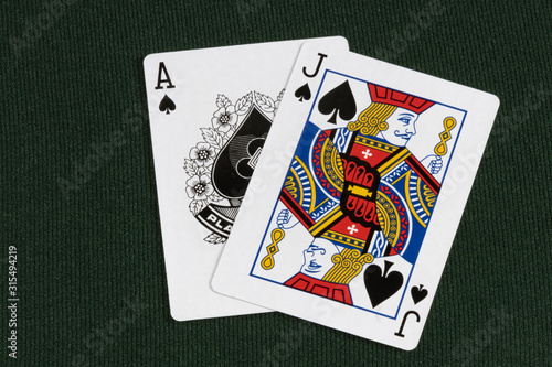 Blackjack twenty one 21 cards spades on green card table top