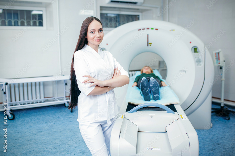 Doctor analyzes the patient on CT Scan in modern hospital Doctor analyzes the patient on CT Scan in modern hospital