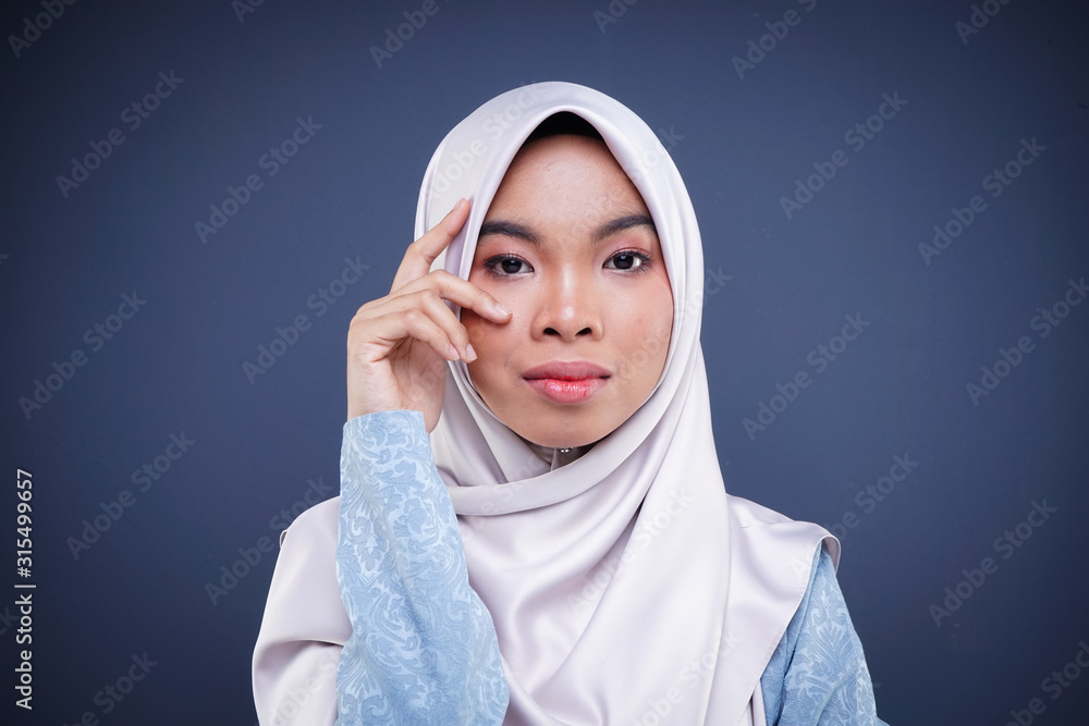 Headshot of a cute Muslim teenager wearing hijab showing various facial expressions isolated on grey background. Landscape orientation. Headshot of a cute Muslim teenager wearing hijab showing various facial expressions isolated on grey background. Landscape orientation.