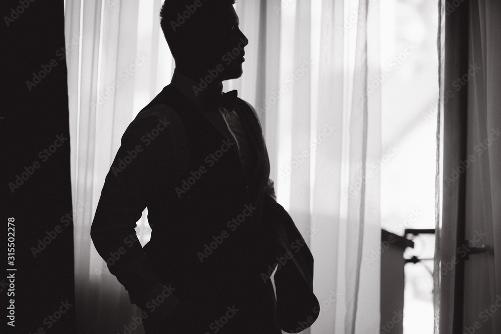 Silhouette of groom in the morning at hotel