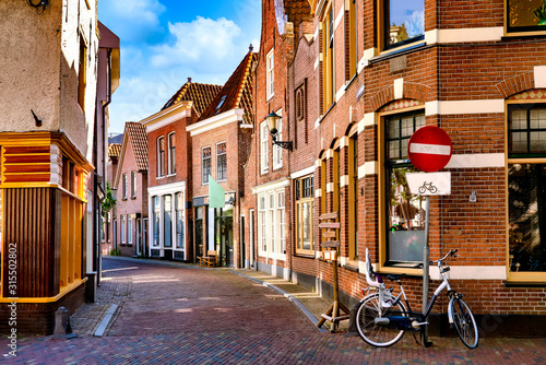 Narrow Street in the historic old town of Alkmaar, North Holland, with typical dutch houses