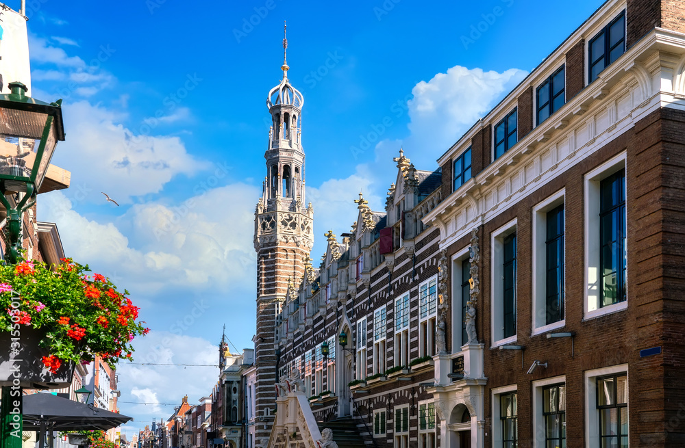 Fototapeta premium Historic old town of Alkmaar, North Holland, with typical dutch houses and the bell tower of the Grote Kerk