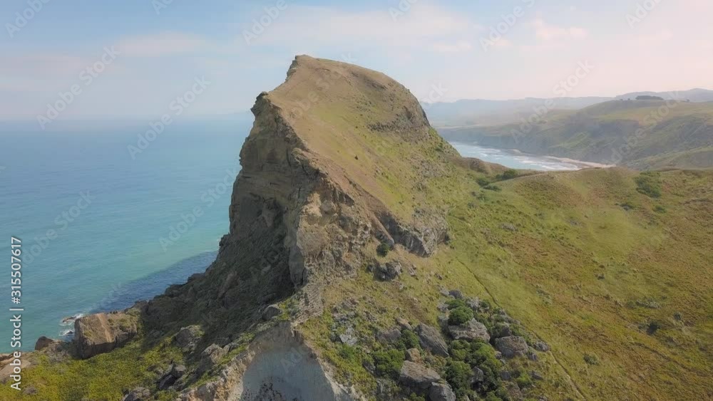 Aerial view rising over Castle Rock on the shoreline of Castlepoint, New Zealand Aerial view rising over Castle Rock on the shoreline of Castlepoint, New Zealand