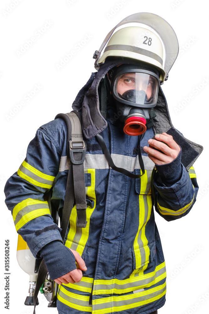 young firefighter in uniform using protective breathing mask on his head.