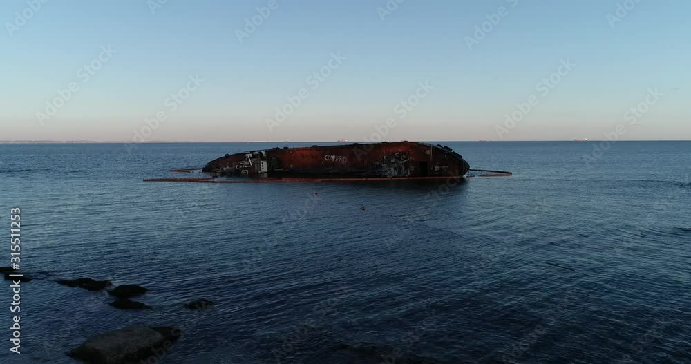 Aerial view of bunker tanker sunken in coastal zone. An old tanker sunken in coastline. Ecological catastrophe. Tanker was thrown to the beach. Aerial view of bunker tanker sunken in coastal zone. An old tanker sunken in coastline. Ecological catastrophe. Tanker was thrown to the beach.