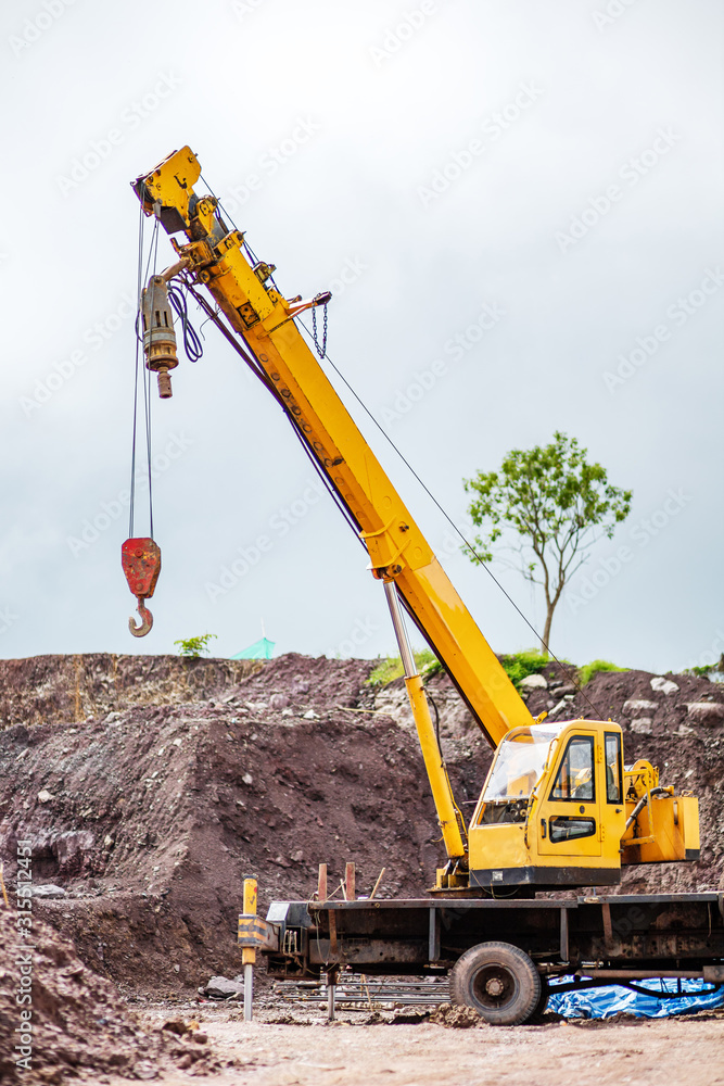 Truck crane standing on a construction site. Truck crane standing on a construction site.