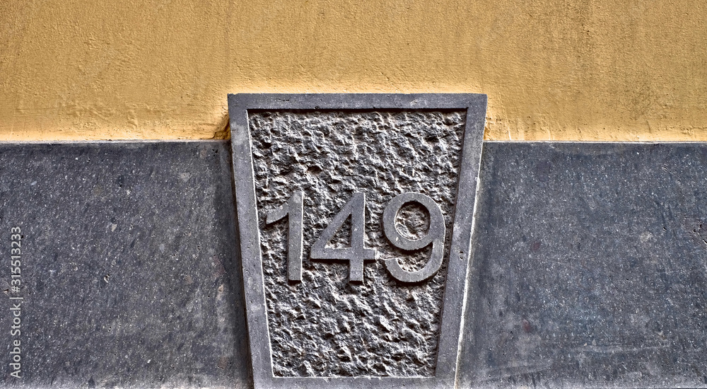 Number 149, one hundred and forty-nine, plate carved in stone. Number 149, one hundred and forty-nine, plate carved in stone.