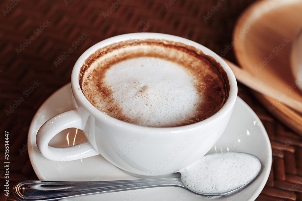 hot cup of coffee on the wood table in the morning. hot cup of coffee on the wood table in the morning.
