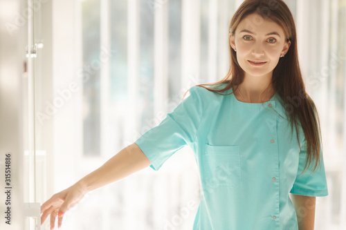 Free Download Female cosmetologist in green robe. Beautiful doctor in beauty salon - GFXLoad