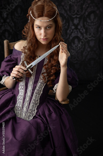 Renaissance or Victorian woman on a dark backdrop photo