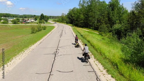 Cycle Touring Road Bikes to Backpacking Camping Travel Trail to Bois Blanc Island and Mackinac Island Country Roads fallowing cyclists down old road photo