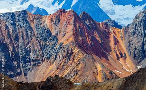 Mountain landscape. Snow-capped peaks, colored rocks.