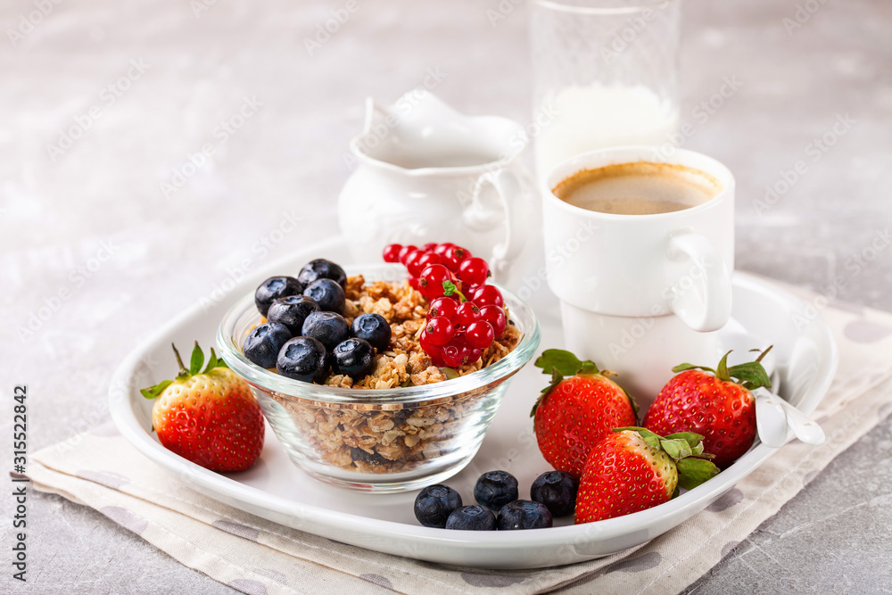 Breakfast - muesli, berries and coffee. Selective focus. Copy space Breakfast - muesli, berries and coffee. Selective focus. Copy space
