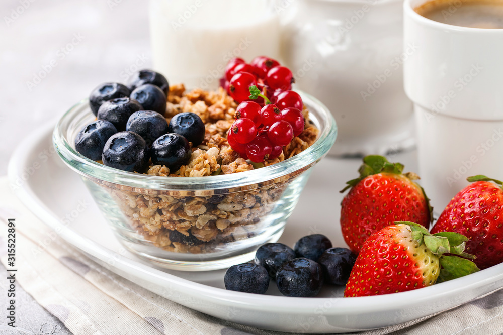 Breakfast - muesli, berries and coffee. Selective focus. Copy space Breakfast - muesli, berries and coffee. Selective focus. Copy space