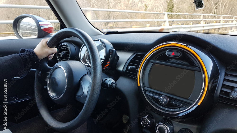 Fototapeta premium steering wheel drivers hands and modern black car