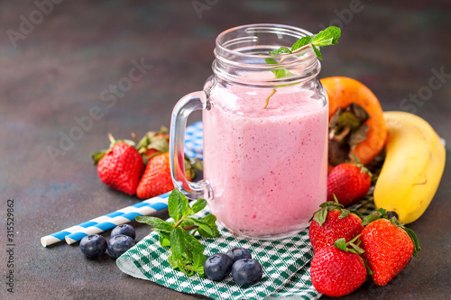 Smoothie in a jar and berries on a table. Selective focus. Copy space.