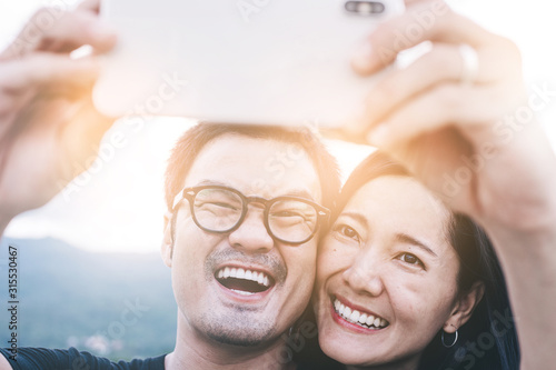 couple love concept.asian lover man and women taking a selfie while travelling on holiday hug each other.photo of people smile enjoy  Beautiful romantic time