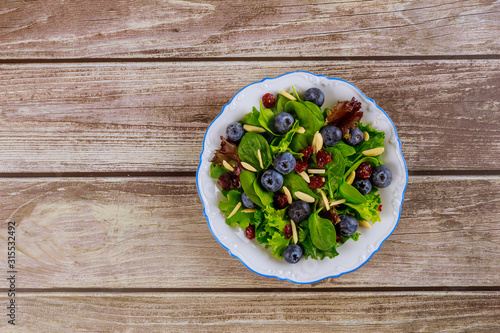 Spinach salad with cranberry, blueberry and slivered almond.