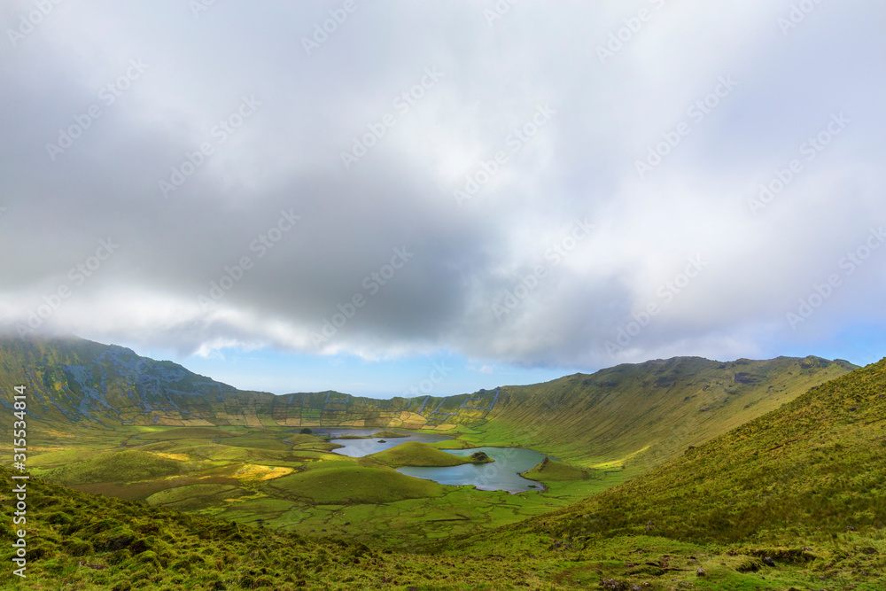 Clouds murmur above the mysterious Corvo Crater on the island of Corvo in the Azores, Portugal.