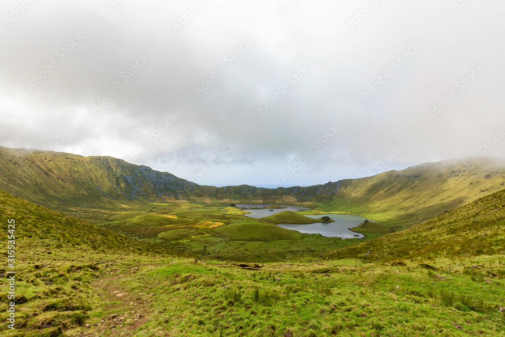 The magnificent Corvo Caldera on a summer morning on the island of Corvo in the Azores, Portugal. The magnificent Corvo Caldera on a summer morning on the island of Corvo in the Azores, Portugal.