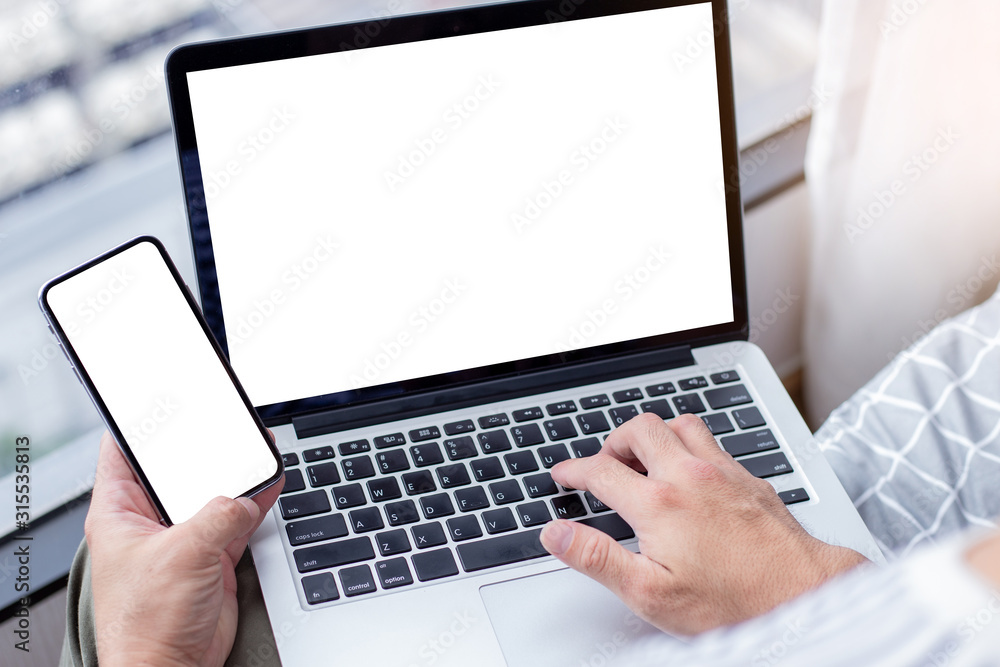 mockup image blank screen computer with white background for advertising text,hand man using laptop contact business search information at home office.marketing and creative design mockup image blank screen computer with white background for advertising text,hand man using laptop contact business search information at home office.marketing and creative design