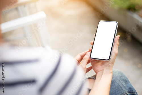 Mockup image blank white screen cell phone.man hand holding texting using mobilebackground empty space for advertise text.people contact marketing business,technology  photo