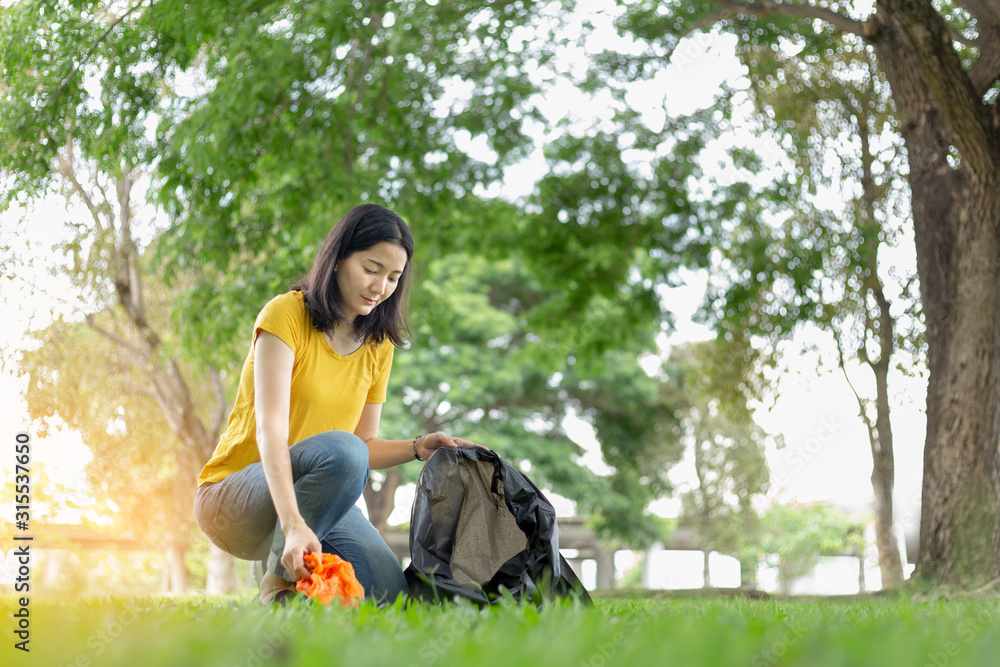 environment protection pollution problems and global warming,plastic waste caring about nature concept.Volunteer women carrying garbage bags, garbage collection, cleaning in the national park