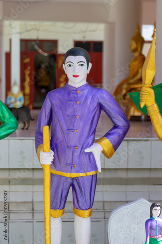 Angle statue holding arm at the temple