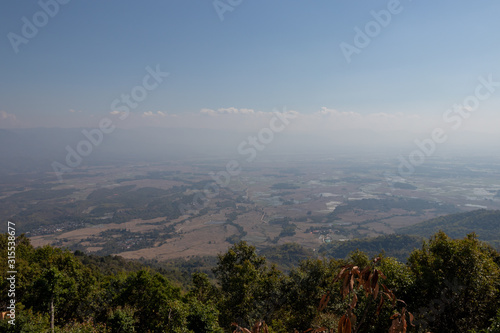 Misty landscape of rice filed under blue sky in Keng Tung, Shan State, Myanmar