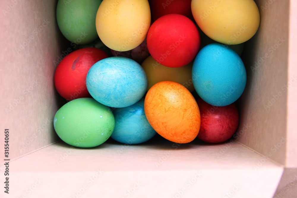 lots of multi-colored Easter eggs in a white square box. Easter preparations. Painting eggs. painted eggs. tinting. lots of multi-colored Easter eggs in a white square box. Easter preparations. Painting eggs. painted eggs. tinting.