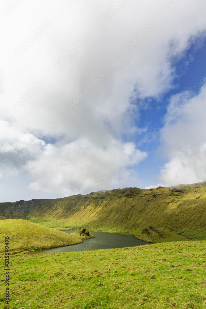 Fototapeta premium Various geologic formations in the basin of the Corvo caldera on the island of Corvo in the Azores, Portugal.
