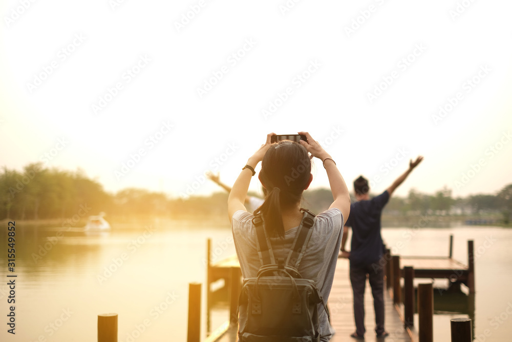 asian take a photograph happy asian family at lake in the evening in thailand asian take a photograph happy asian family at lake in the evening in thailand
